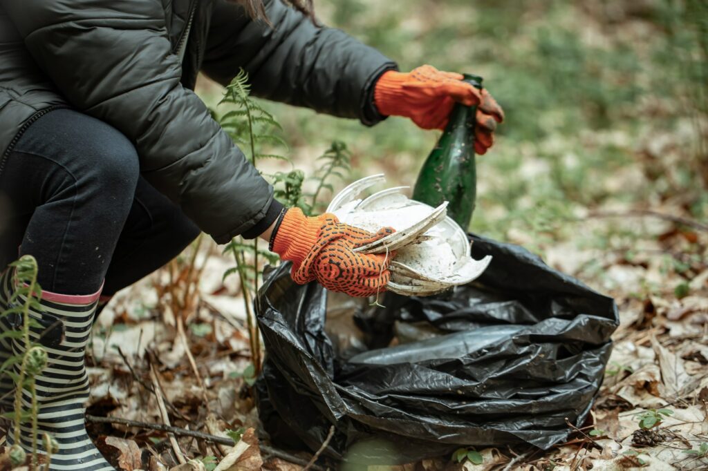Environmental micro-volunteering activity collecting waste in a natural area